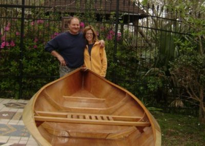 Pirogue builder with partner posing with a pirogue they built